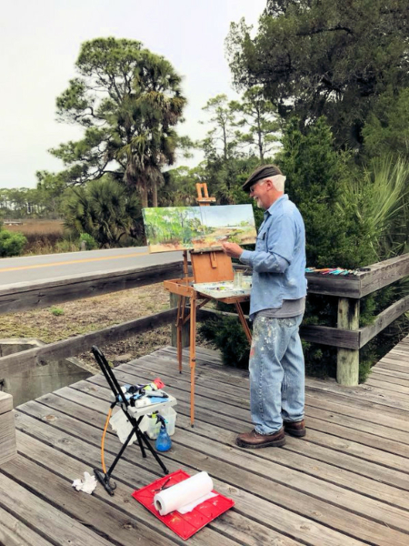 An artist painting the landscape of St. George Plantation.